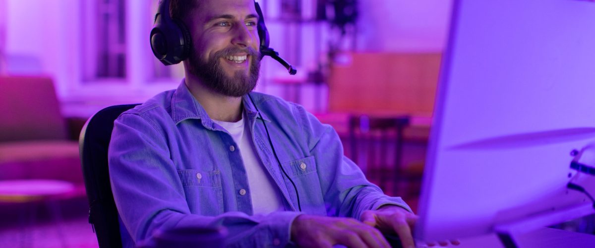 With intense concentration, this millennial guy epitomizes a gamer deeply invested in his match, reflecting the addiction and engagement of home gaming
