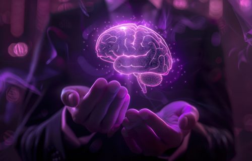 Hands presenting a glowing, holographic brain emitting a purple hue.
