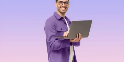 portrait-young-modern-businessman-holding-laptop-looking-camera-isolated-purple-2048x1366