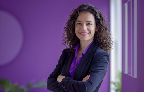 woman-with-her-arms-crossed-front-purple-wall